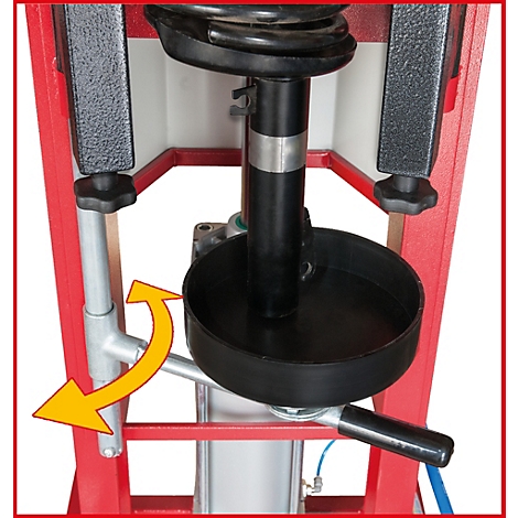 Hydraulische Federbeinpresse; schwarze Feder mit schwarzem Teller; roter Rahmen; gelber Pfeil zeigt die Bewegung an.